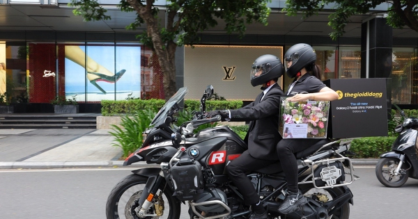 Shipper Thế Giới Di Động mặc vest đen, đi mô tô phân khối lớn để giao điện thoại cho khách